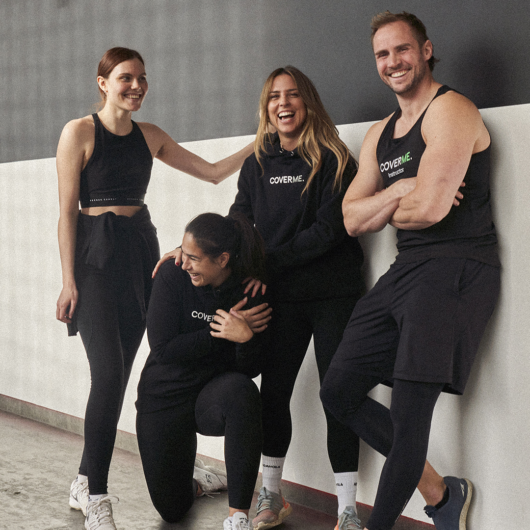 CoverMe team of fitness instructors in branded kit posing together
